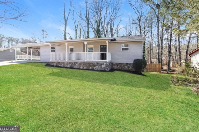 view of front of house featuring a carport, a front yard, and covered porch