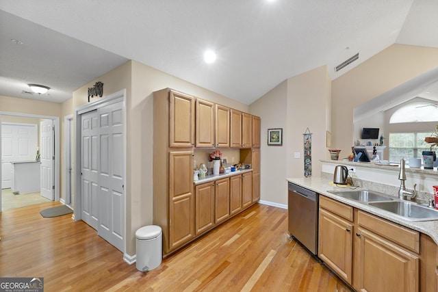 kitchen featuring lofted ceiling, sink, stainless steel dishwasher, and light wood-type flooring