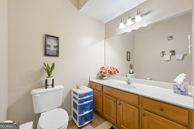 bathroom with tile patterned floors, vanity, and toilet