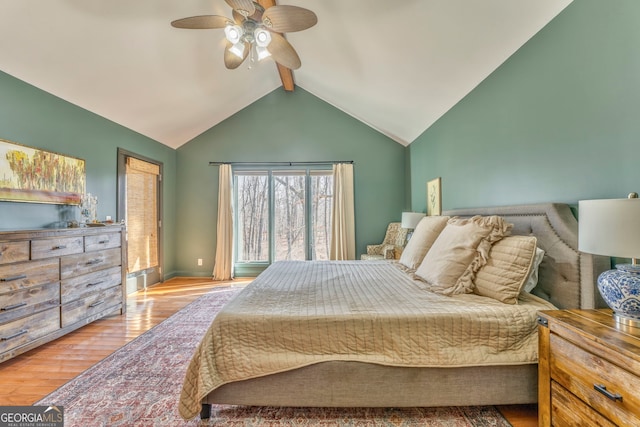 bedroom featuring ceiling fan, light hardwood / wood-style flooring, and vaulted ceiling with beams