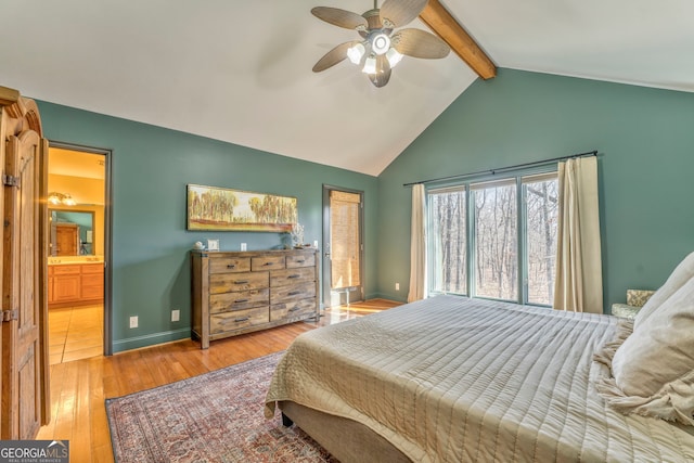 bedroom featuring wood-type flooring, vaulted ceiling with beams, ceiling fan, and ensuite bath