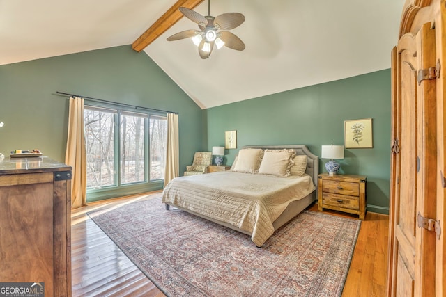 bedroom featuring lofted ceiling with beams, ceiling fan, and light wood-type flooring