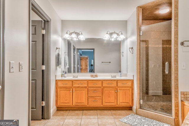 bathroom with vanity, a shower with shower door, and tile patterned flooring