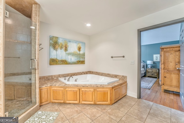 bathroom featuring shower with separate bathtub and tile patterned floors