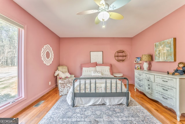 bedroom featuring multiple windows, ceiling fan, and light hardwood / wood-style floors