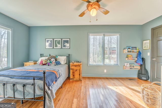 bedroom with ceiling fan and light hardwood / wood-style flooring