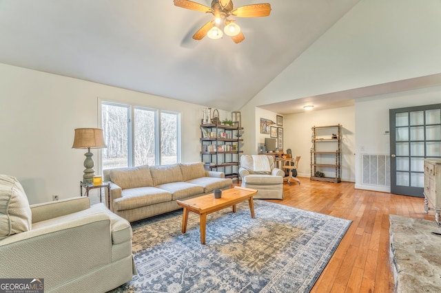 living room featuring ceiling fan, high vaulted ceiling, and light hardwood / wood-style floors