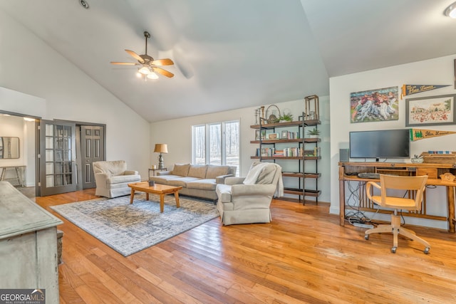 living room with ceiling fan, high vaulted ceiling, and light hardwood / wood-style floors