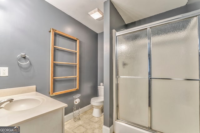 bathroom featuring walk in shower, vanity, and toilet