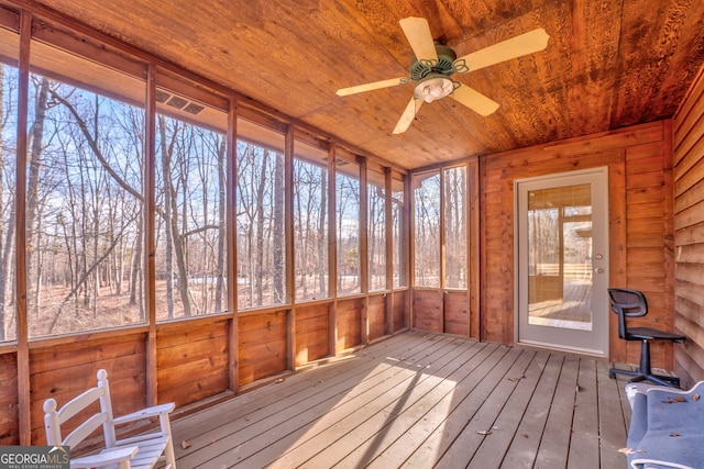 unfurnished sunroom with ceiling fan and wood ceiling