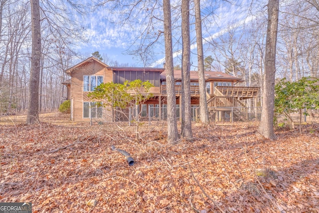 view of front of home featuring a sunroom and a deck