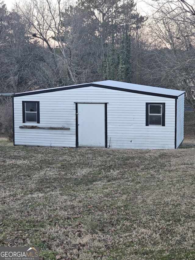 view of outdoor structure with a lawn