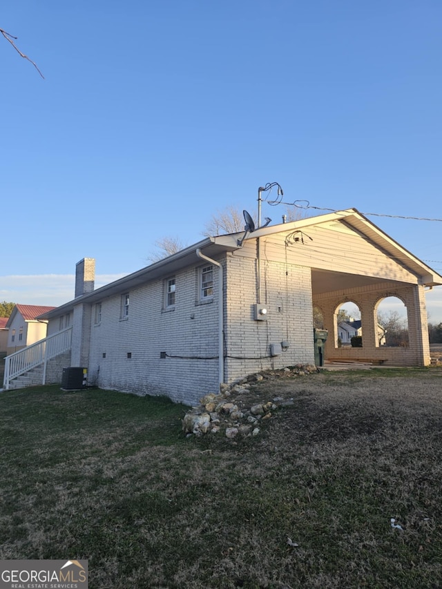 view of property exterior featuring a yard and central AC