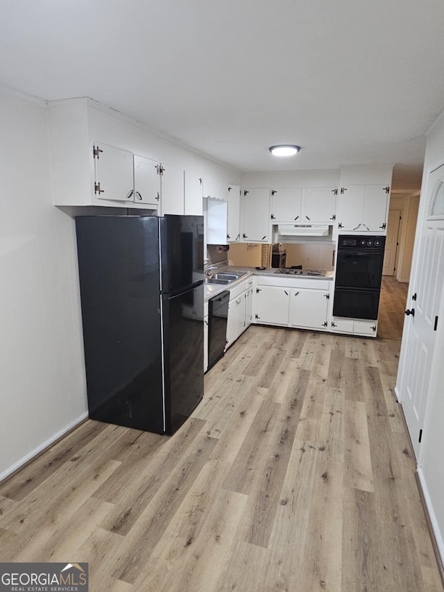 kitchen with white cabinetry, sink, light hardwood / wood-style flooring, and black appliances