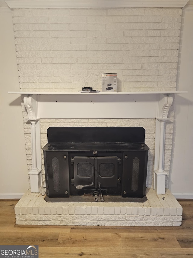 details featuring hardwood / wood-style flooring and a wood stove