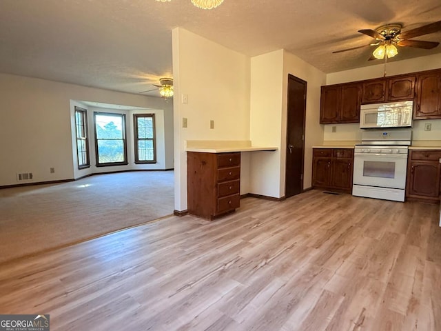 kitchen featuring white appliances, dark brown cabinetry, ceiling fan, a textured ceiling, and light wood-type flooring