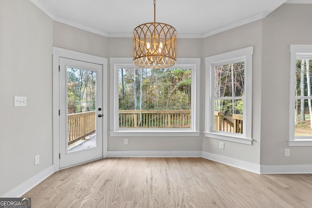 interior space featuring crown molding, a chandelier, and light hardwood / wood-style floors