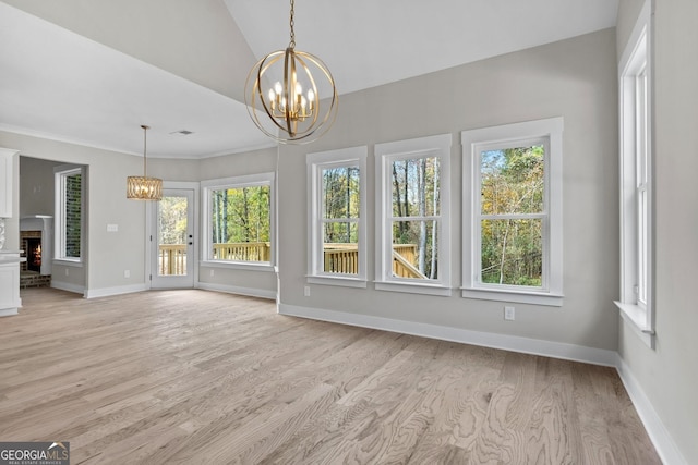 interior space with a notable chandelier, a wealth of natural light, and vaulted ceiling