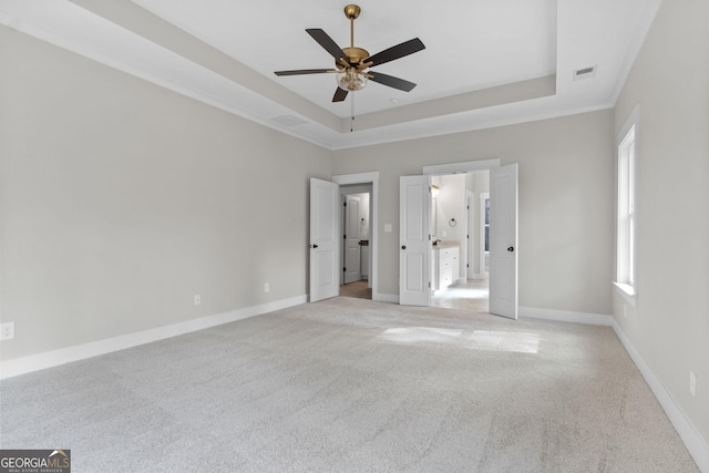 interior space featuring crown molding, ceiling fan, and a tray ceiling