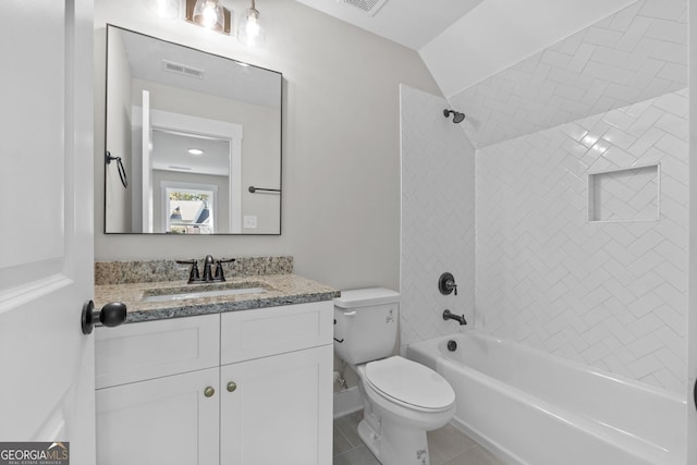 full bathroom featuring vanity, tiled shower / bath, vaulted ceiling, tile patterned floors, and toilet