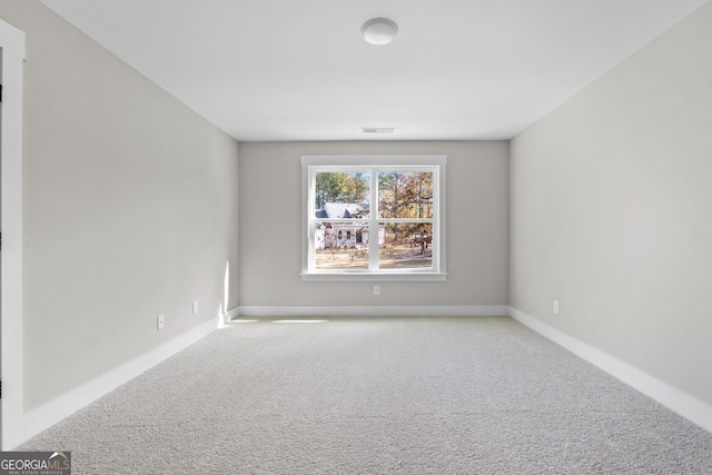 empty room featuring light carpet