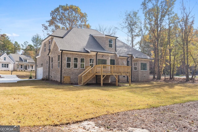 rear view of house featuring a deck and a lawn