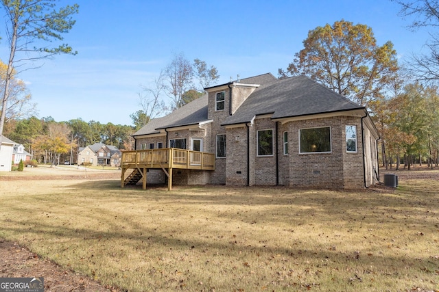 back of house featuring a wooden deck, central AC unit, and a lawn