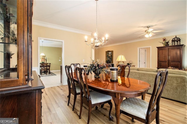 dining space featuring crown molding, ceiling fan with notable chandelier, and light hardwood / wood-style floors