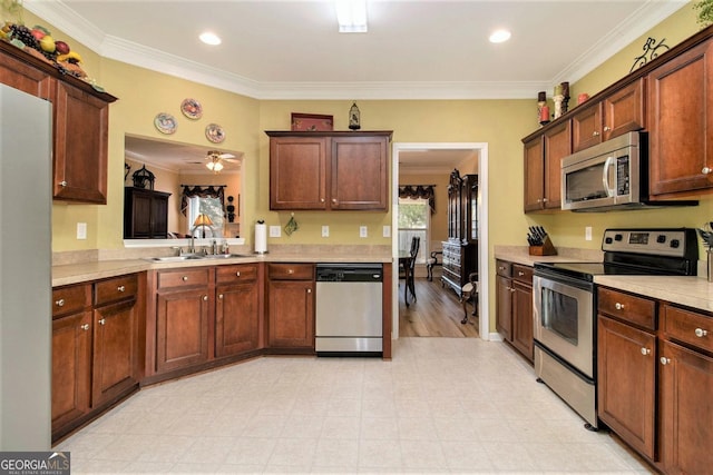 kitchen featuring sink, crown molding, ceiling fan, and appliances with stainless steel finishes