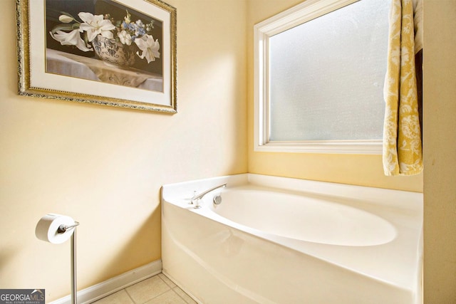 bathroom with tile patterned flooring and a washtub