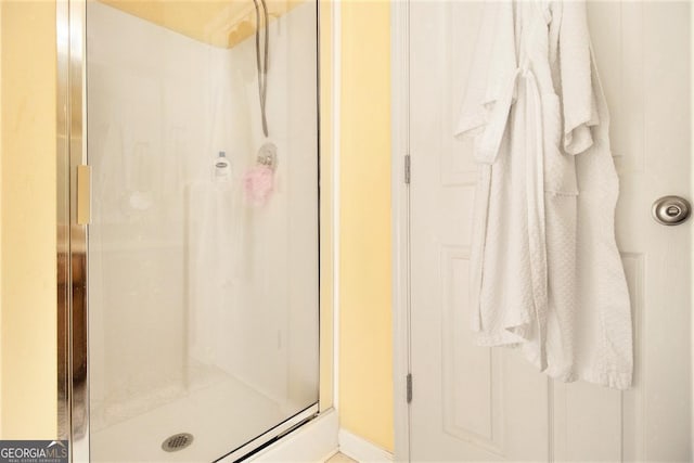 bathroom featuring a shower with shower door