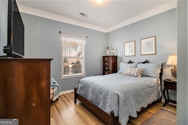 bedroom featuring crown molding and light wood-type flooring