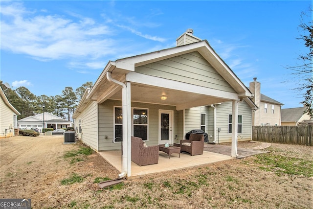 rear view of house with central air condition unit and a patio area