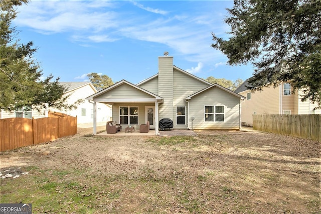 back of house with a patio