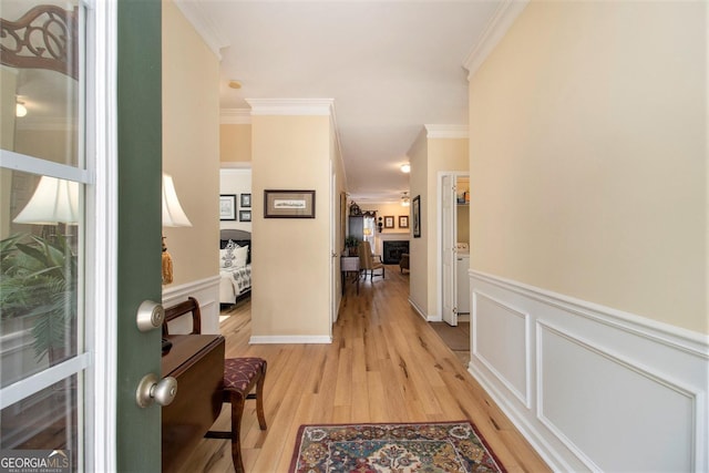 hall featuring crown molding and light hardwood / wood-style floors