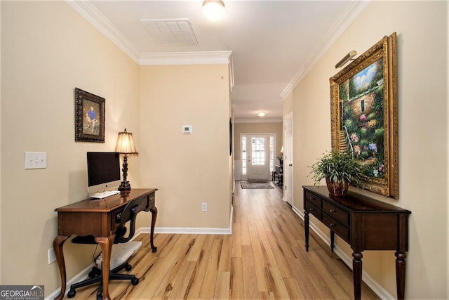 hall with crown molding and light hardwood / wood-style floors