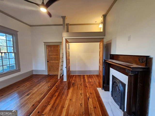 unfurnished living room featuring ornamental molding and dark hardwood / wood-style floors