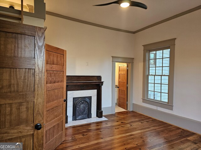 213 W Hightower Trl, Social Circle, GA 30025 - unfurnished living room featuring crown molding, ceiling fan, wood-type flooring, and a fireplace with flush hearth