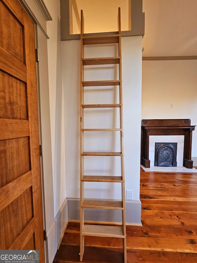 213 W Hightower Trl, Social Circle, GA 30025 - stairs featuring wood finished floors, a fireplace, and crown molding
