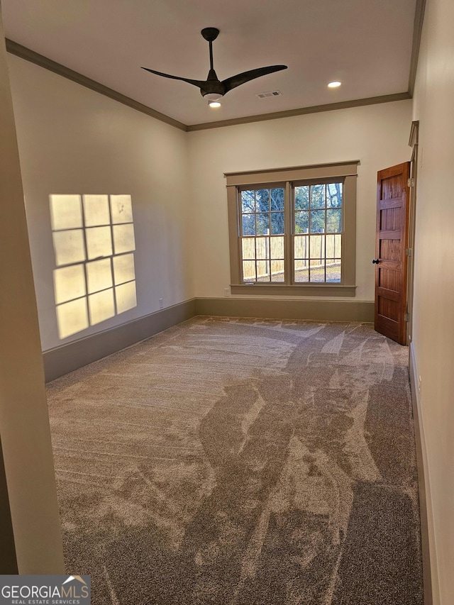 carpeted empty room with ornamental molding, a baseboard heating unit, and ceiling fan