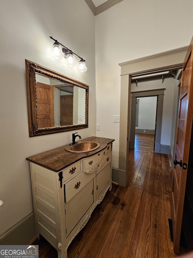 213 W Hightower Trl, Social Circle, GA 30025 - bathroom featuring hardwood / wood-style flooring, vanity, and ornamental molding