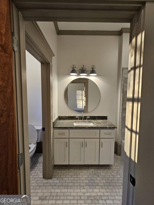 213 W Hightower Trl, Social Circle, GA 30025 - bathroom with brick patterned flooring, toilet, vanity, and ornamental molding