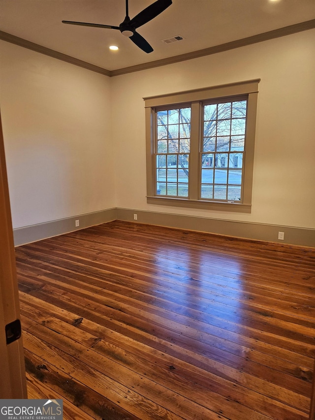 spare room with dark hardwood / wood-style flooring, ornamental molding, and ceiling fan