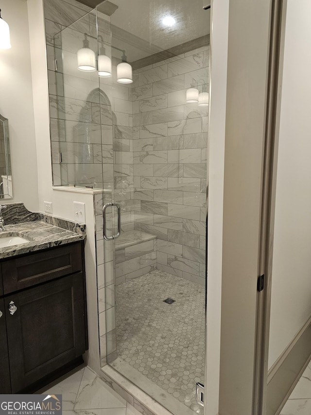 bathroom featuring vanity and a shower with shower door