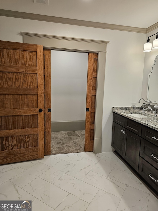 213 W Hightower Trl, Social Circle, GA 30025 - bathroom featuring marble look tile flooring, crown molding, and vanity
