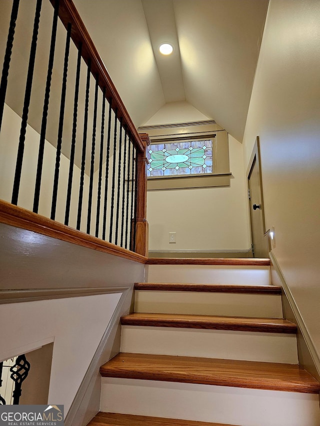 stairway with lofted ceiling