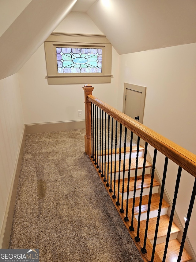 interior space featuring lofted ceiling and carpet floors