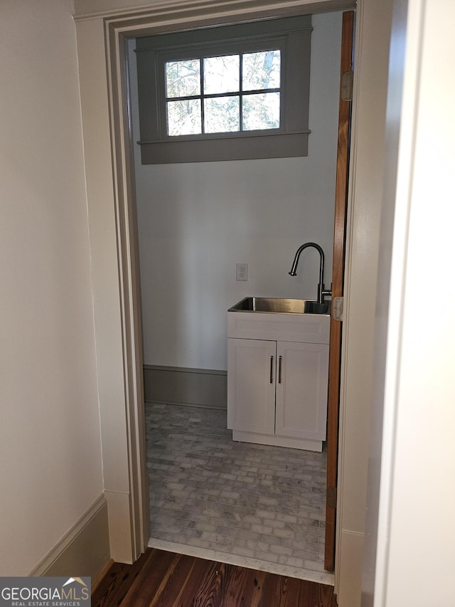 bathroom featuring wood-type flooring and sink