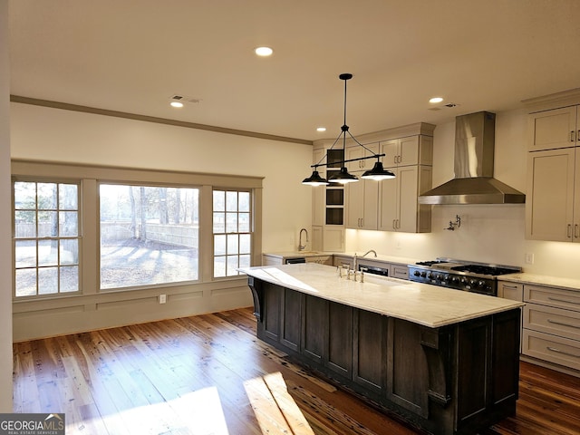 kitchen with dark wood-type flooring, wall chimney exhaust hood, crown molding, range, and light stone countertops