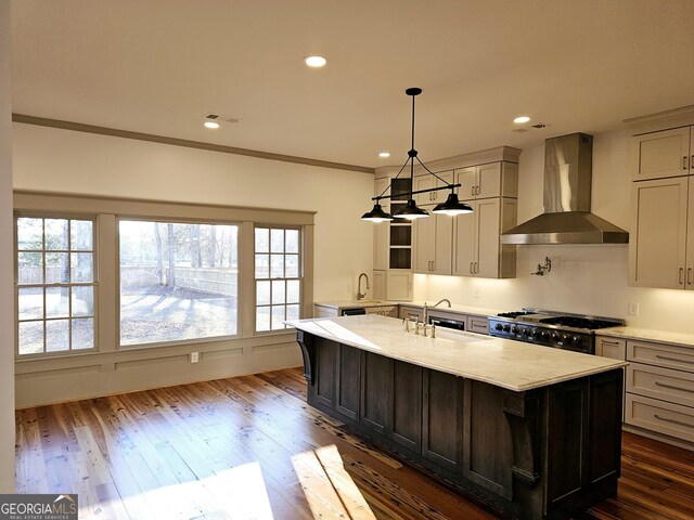 213 W Hightower Trl, Social Circle, GA 30025 - kitchen featuring wall chimney exhaust hood, a sink, dark wood-style floors, an island with sink, and recessed lighting